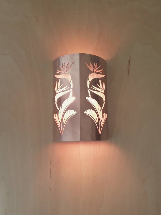 Copper Sconce light with a double cut out of a Bird of Paradise design